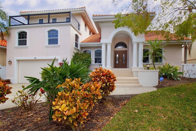 mediterranean / spanish home featuring a garage