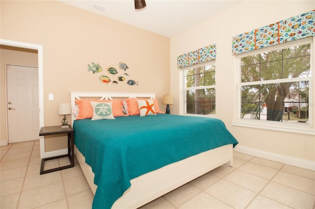 bedroom with ceiling fan and tile patterned flooring