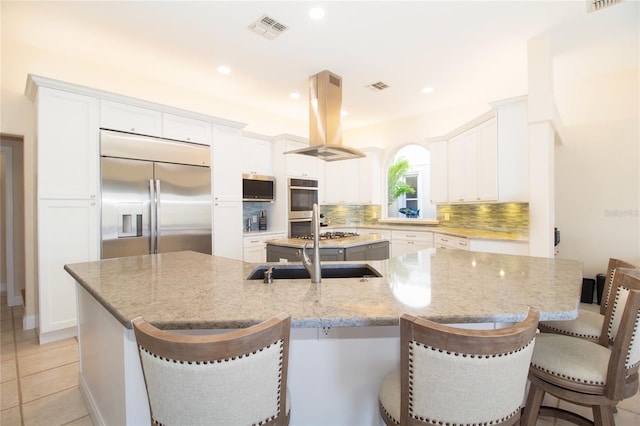 kitchen with a spacious island, island exhaust hood, and stainless steel appliances