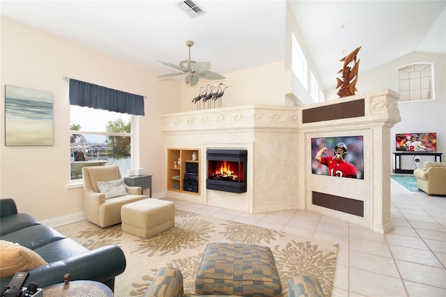 living room featuring ceiling fan, tile patterned floors, and a fireplace