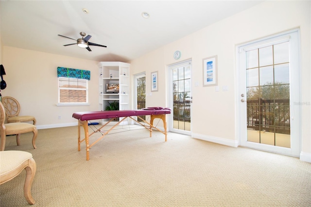 recreation room with a fireplace, plenty of natural light, ceiling fan, and carpet flooring