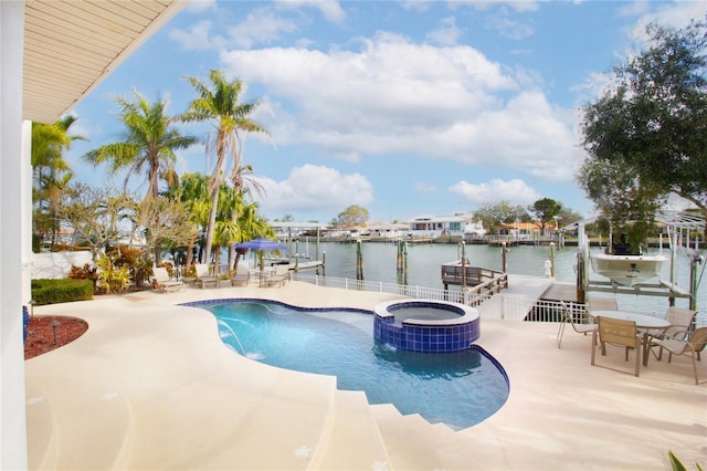 view of swimming pool featuring a water view, a patio area, and an in ground hot tub