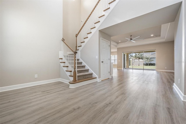 unfurnished living room featuring ceiling fan and light hardwood / wood-style flooring