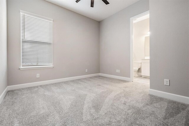 carpeted spare room with ceiling fan