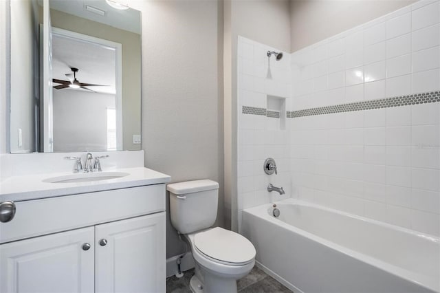 full bathroom with toilet, tiled shower / bath, ceiling fan, and vanity