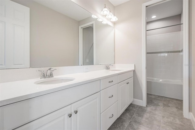 bathroom featuring tiled shower / bath and vanity