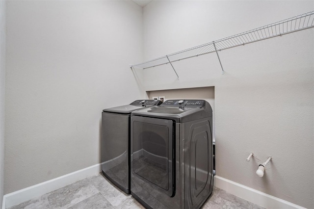 laundry room with washing machine and clothes dryer