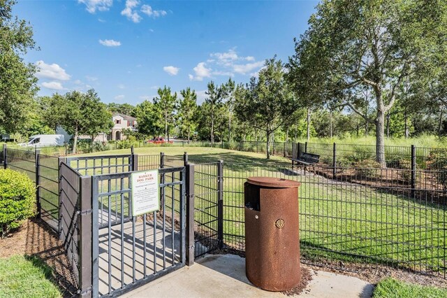 view of gate with a yard