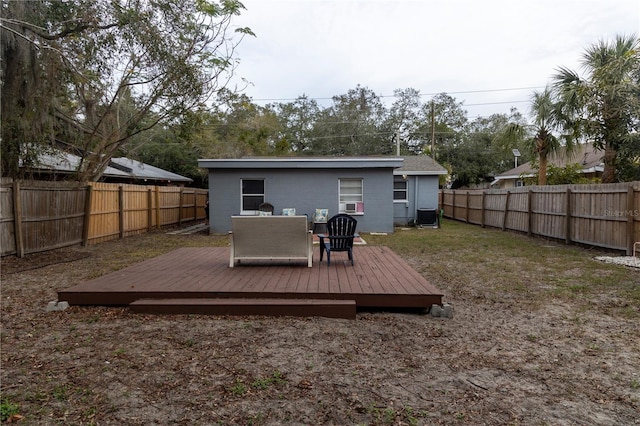 rear view of house with central AC unit and a deck