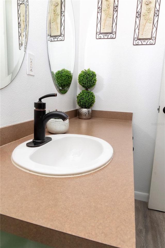 bathroom featuring hardwood / wood-style flooring and vanity