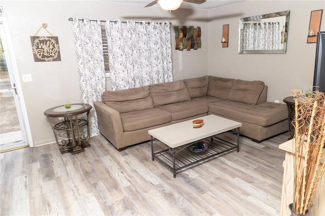 living room featuring ceiling fan and hardwood / wood-style floors