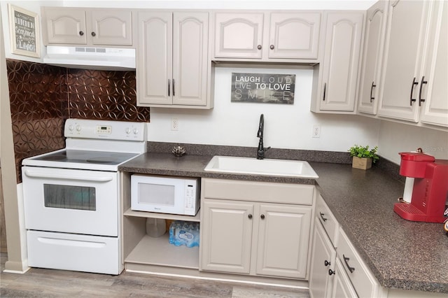 kitchen featuring sink, white appliances, white cabinetry, and hardwood / wood-style flooring