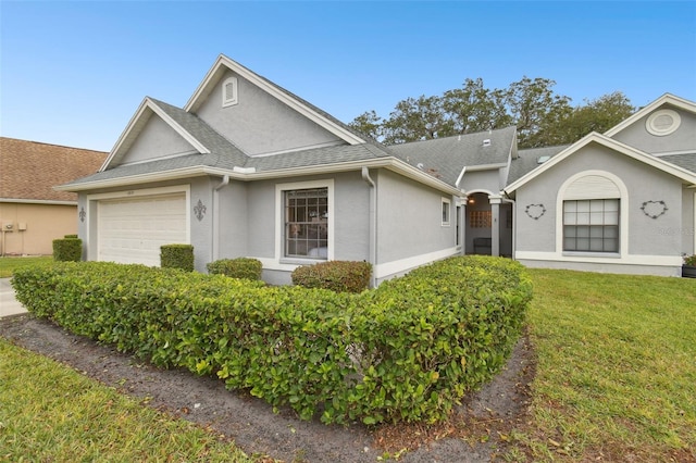 ranch-style home featuring a garage and a front yard