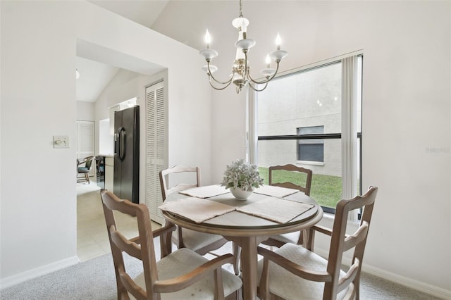 dining space with lofted ceiling, light carpet, and a notable chandelier