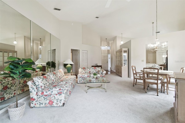 carpeted living room featuring high vaulted ceiling and a notable chandelier