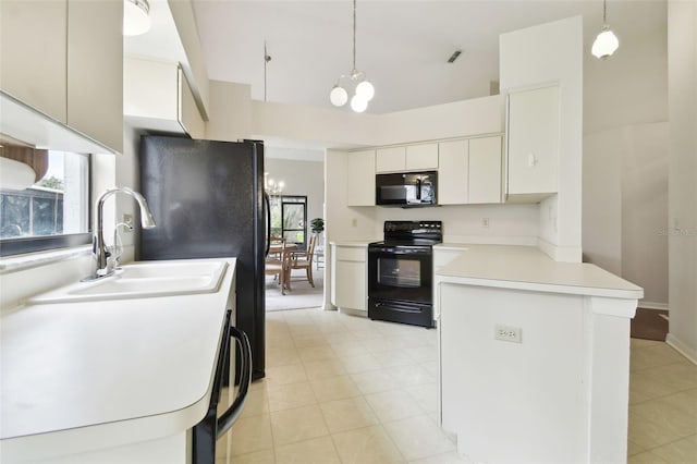 kitchen with pendant lighting, black appliances, kitchen peninsula, and a notable chandelier