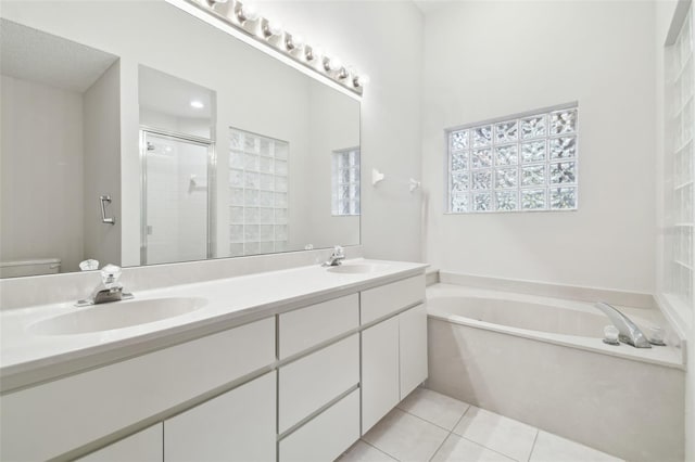 full bathroom with toilet, tile patterned flooring, shower with separate bathtub, and vanity