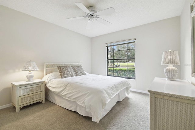 carpeted bedroom with a textured ceiling and ceiling fan