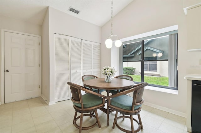 dining area with lofted ceiling and an inviting chandelier