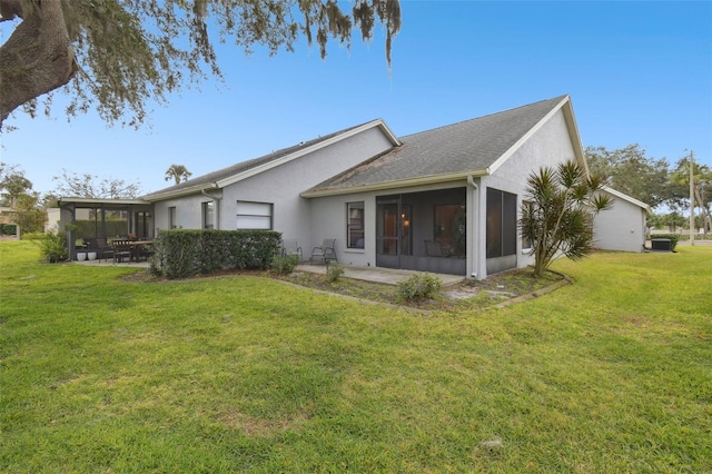 back of property with a lawn, central air condition unit, a patio, and a sunroom