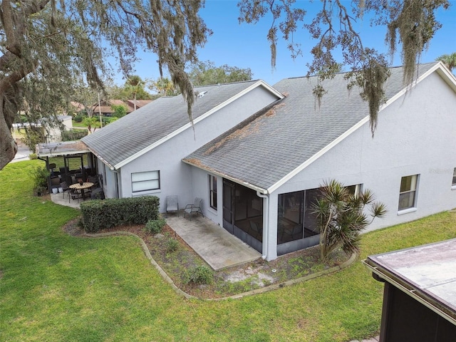 back of house featuring a sunroom, a yard, and a patio