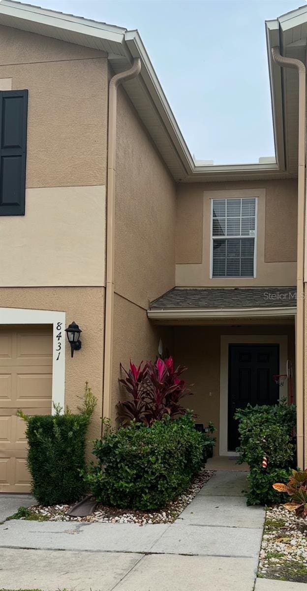 doorway to property with a garage