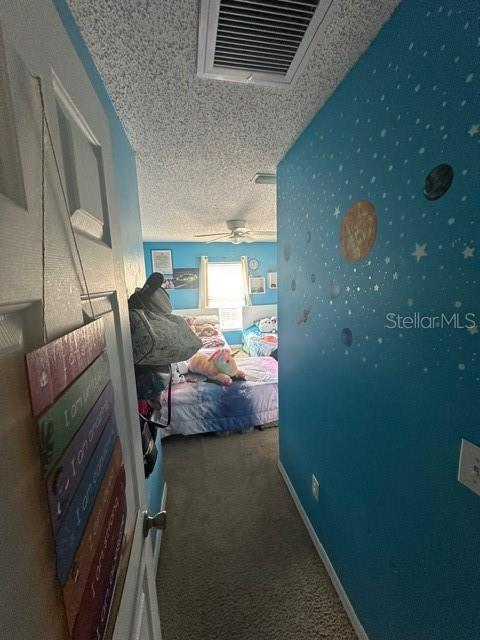 carpeted bedroom with a textured ceiling