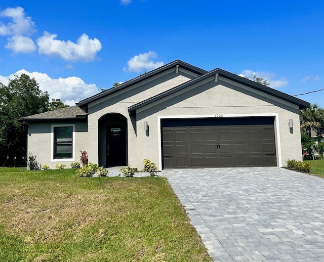 view of front of home featuring a garage and a front lawn