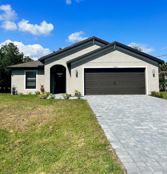 single story home with a garage and a front yard