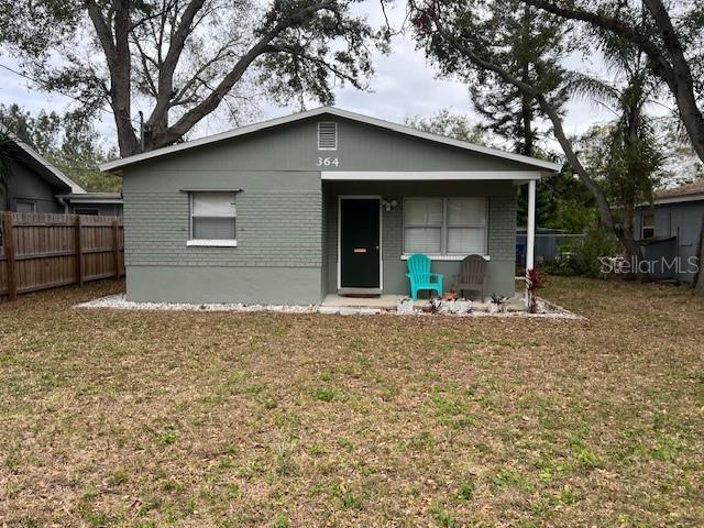 rear view of property with a yard