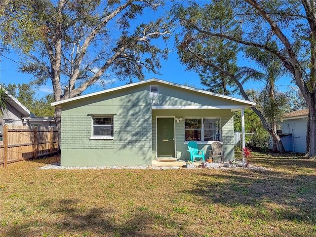 rear view of property featuring a yard