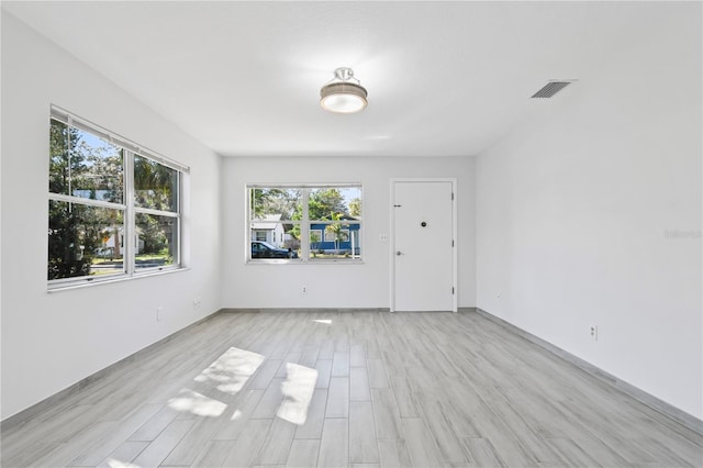 spare room featuring light wood-type flooring