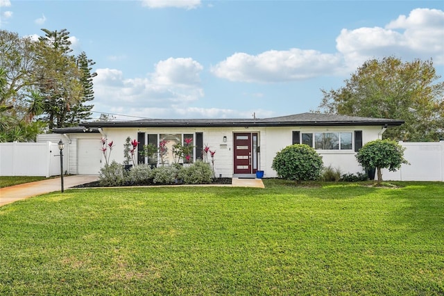 ranch-style home with a front lawn and a garage