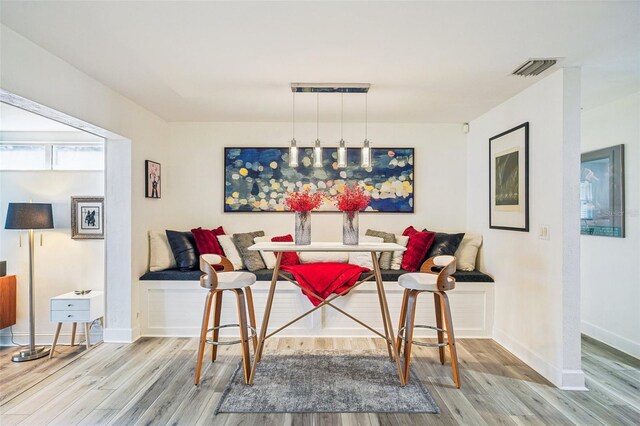 dining space with hardwood / wood-style flooring and breakfast area