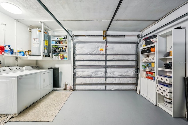 garage with independent washer and dryer and electric water heater