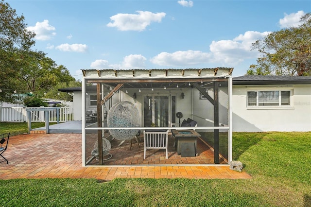 back of house featuring a lawn and a patio