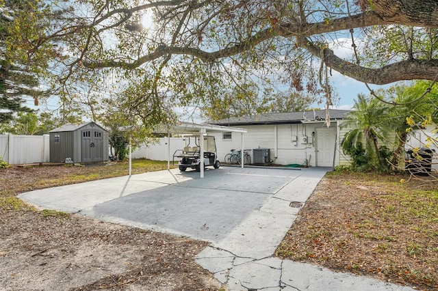 rear view of property with a patio area, cooling unit, and a storage shed