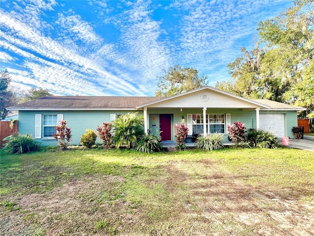 ranch-style house featuring a front yard, a porch, an attached garage, and fence