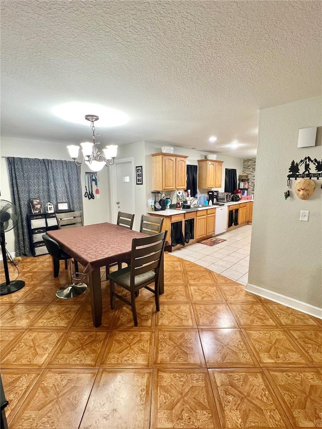 dining space with an inviting chandelier, light tile patterned flooring, and a textured ceiling