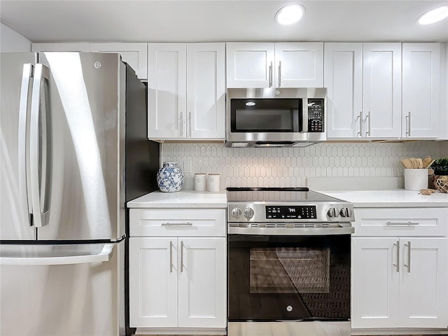 kitchen featuring stainless steel appliances and white cabinetry