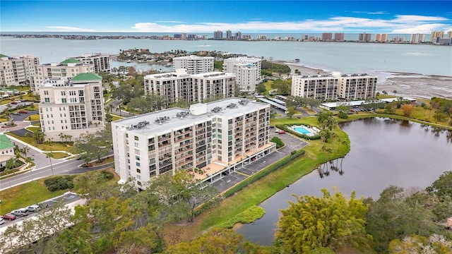 birds eye view of property with a water view and a city view