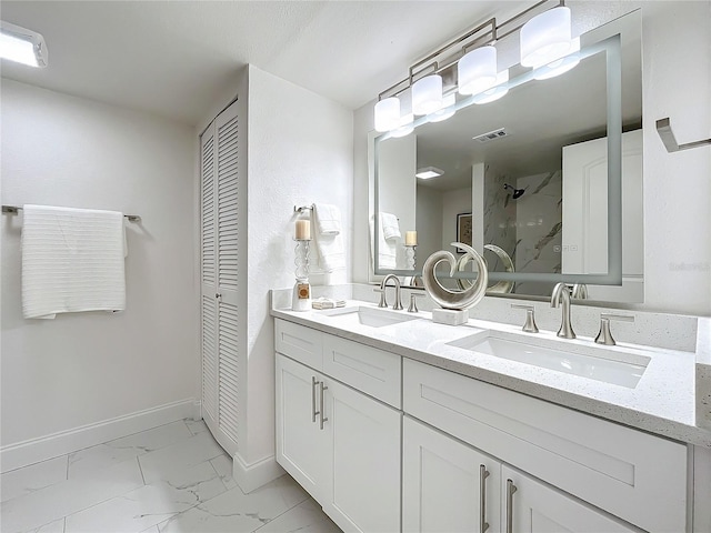 bathroom with marble finish floor, visible vents, a walk in shower, and a sink