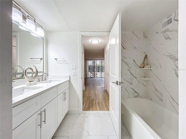 full bath with marble finish floor, double vanity, a sink, and visible vents