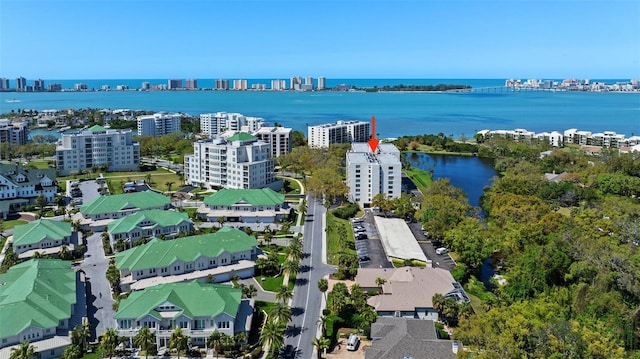 birds eye view of property featuring a water view and a city view