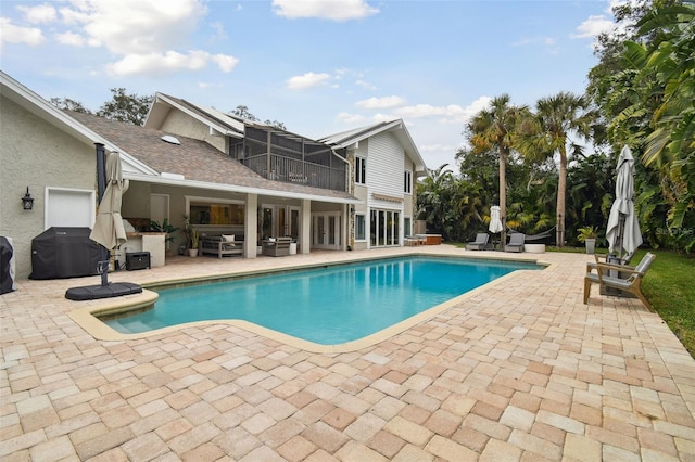 view of swimming pool with a patio and grilling area