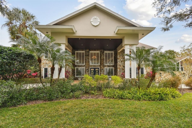 rear view of house featuring a yard