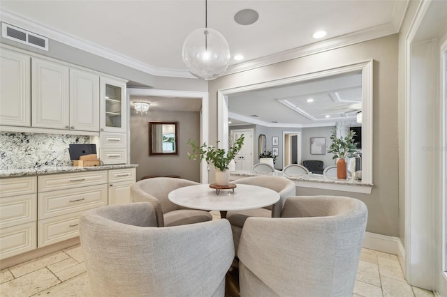 dining space featuring ornamental molding