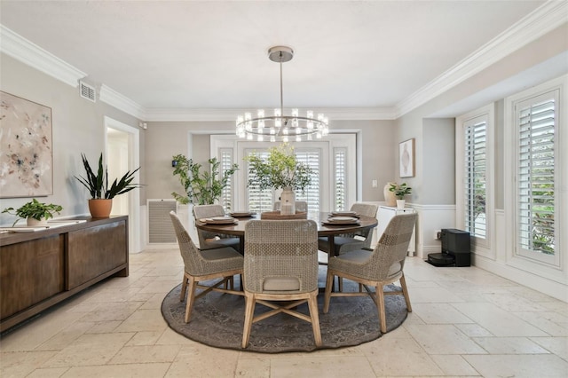 dining space featuring crown molding and a notable chandelier