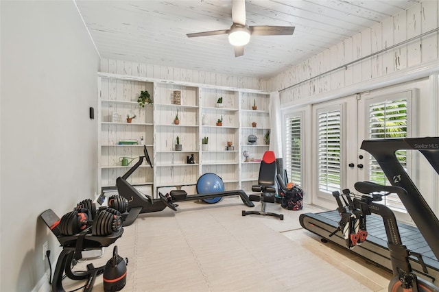 exercise room with ceiling fan and wood ceiling