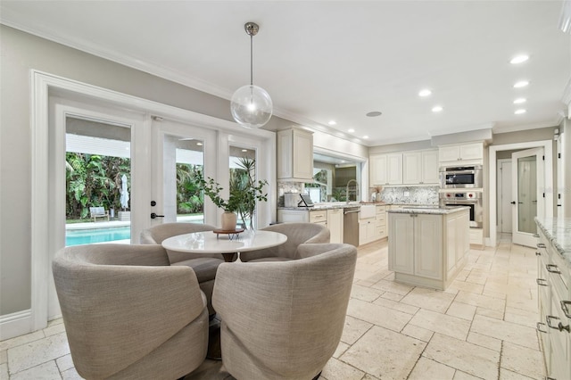 dining space featuring sink and ornamental molding